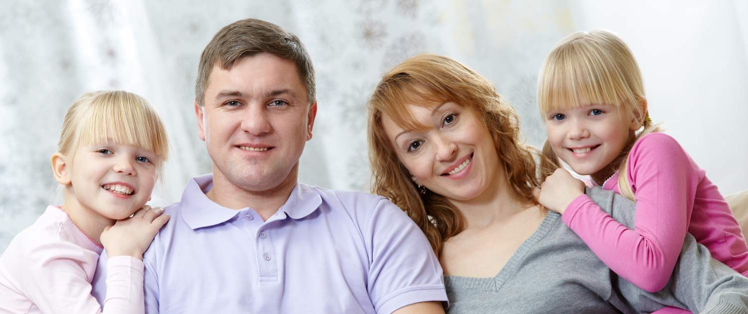 parents with their daughters sitting couch northwest dental